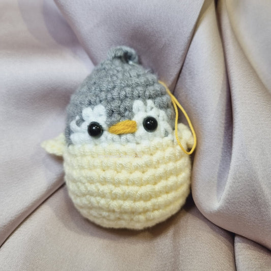 Yellow crochet penguin front view 